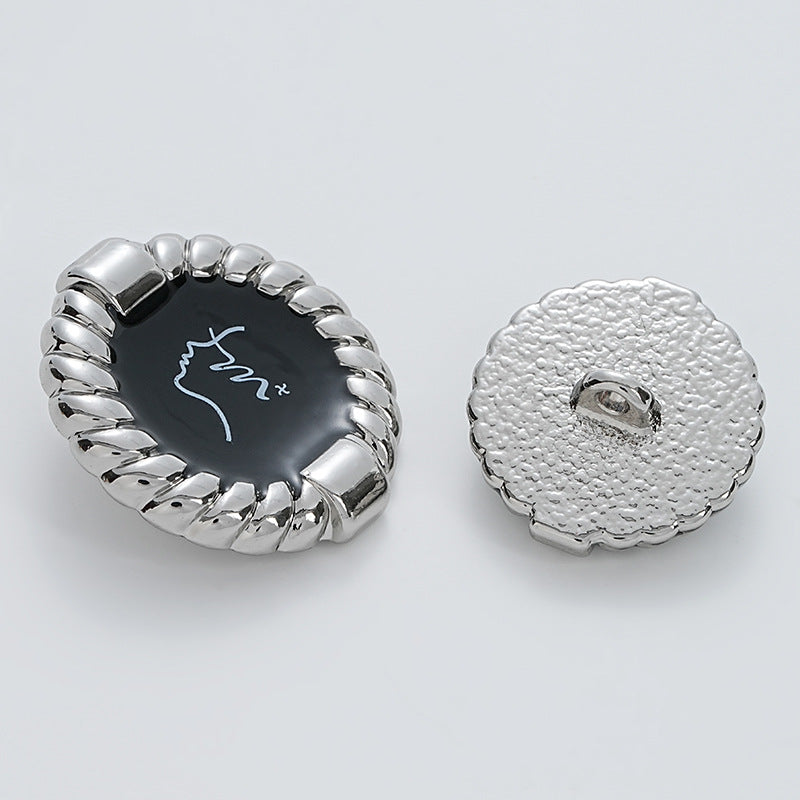 Silver metal button front and back with black glossy face and rope-edge border