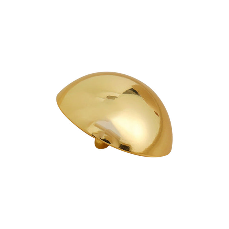 Glossy golden mushroom metal button with shiny curved top