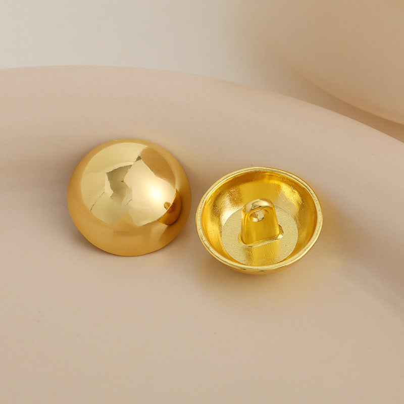 Glossy golden mushroom metal button with 2-hole shank, underside view