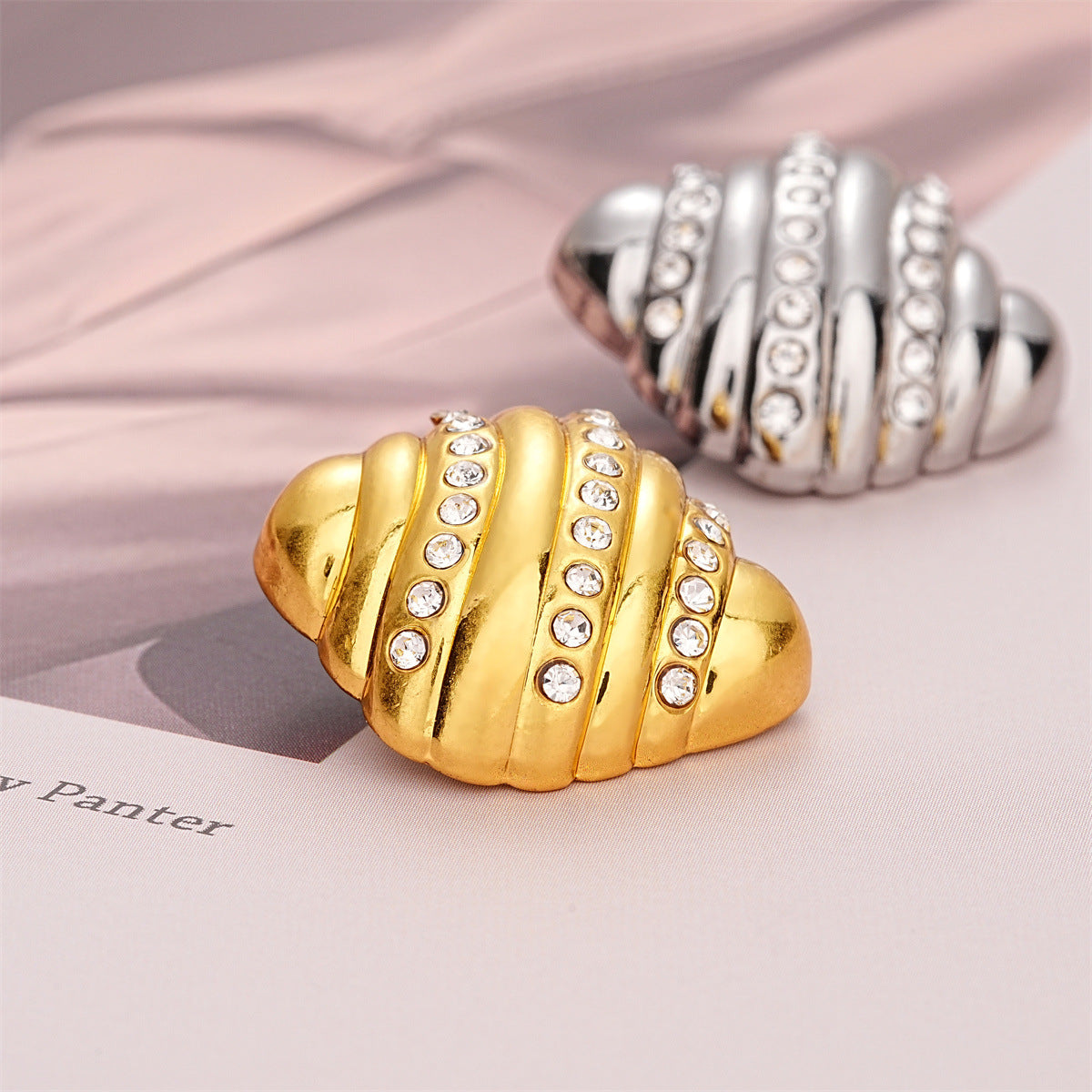 Gold croissant-style metal button with crystal-inlaid ridges, 23mm