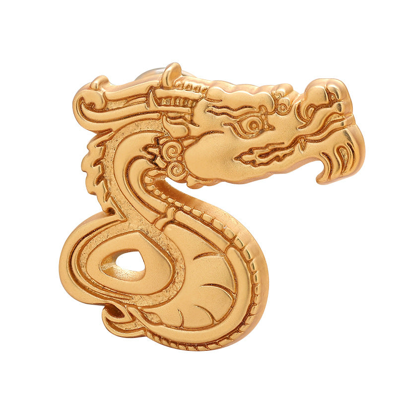Gold-tone dragon zodiac brooch with curled number 6 detail, front view