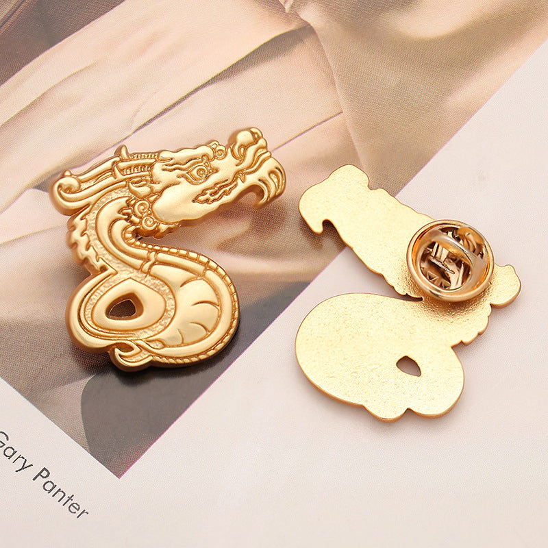 Dragon zodiac brooch set, gold-tone front with butterfly-style clasp back visible