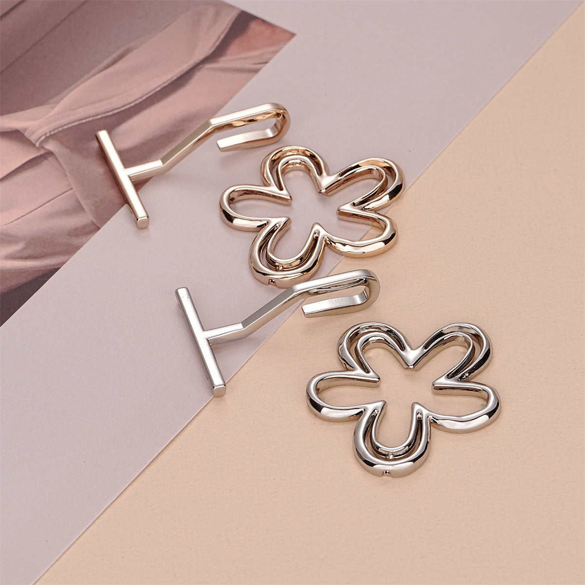 Flower-shaped metal hook buckles with raised bars, gold and silver tones