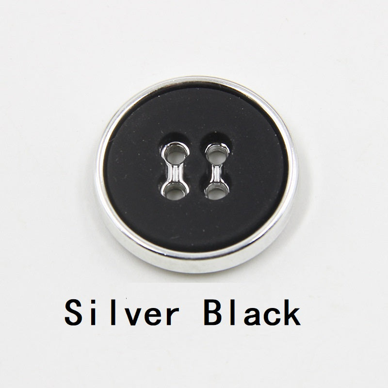 Silver black round plastic button with four-hole design and silver-tone edge