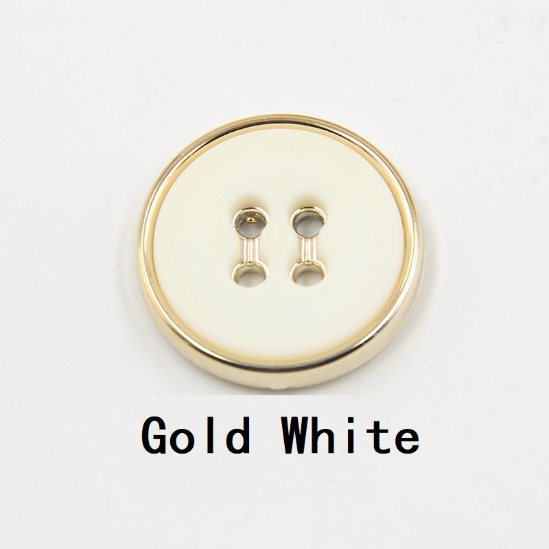 Gold white round plastic button with four-hole design and gold-tone edge
