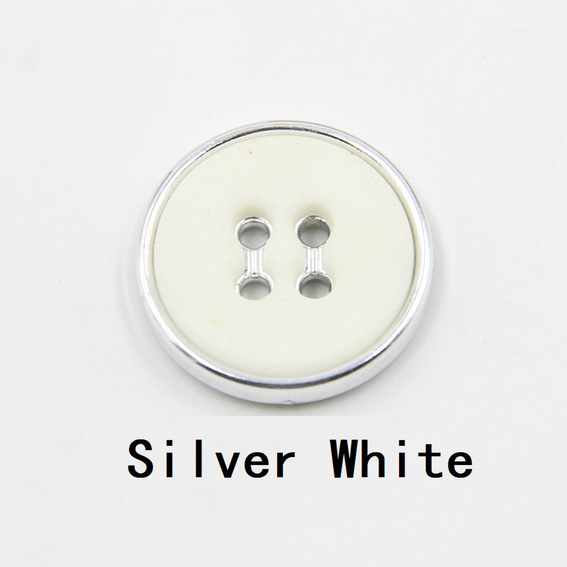 Silver white round plastic button with four-hole design and silver-tone edge