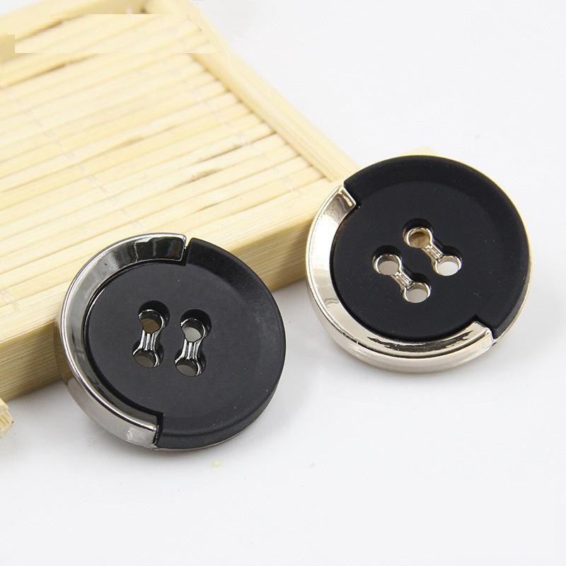 Black plastic buttons with gold trim and 4-hole shanks, shown side-by-side with wood.