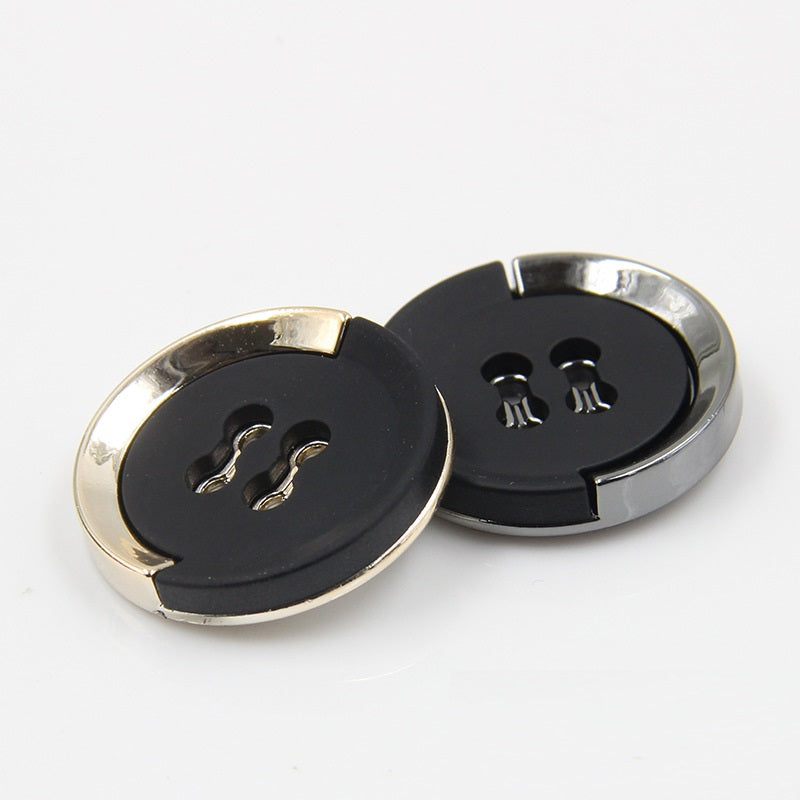Pair of 15–30mm black buttons with gold-trimmed rims and 4-hole centers for sewing.