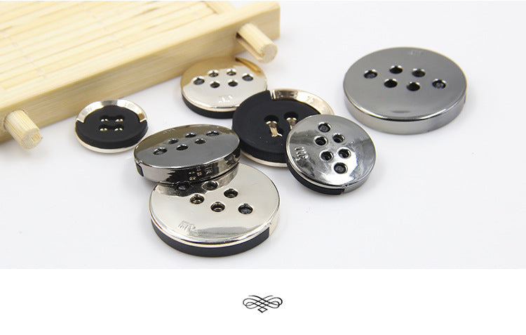 Mixed sizes of black buttons with gold-plated rims and 4-hole sew-on faces (variety set).