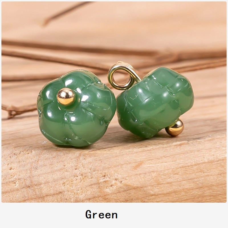 Green pumpkin-shaped glazed cheongsam buttons with gold-tone posts and loops