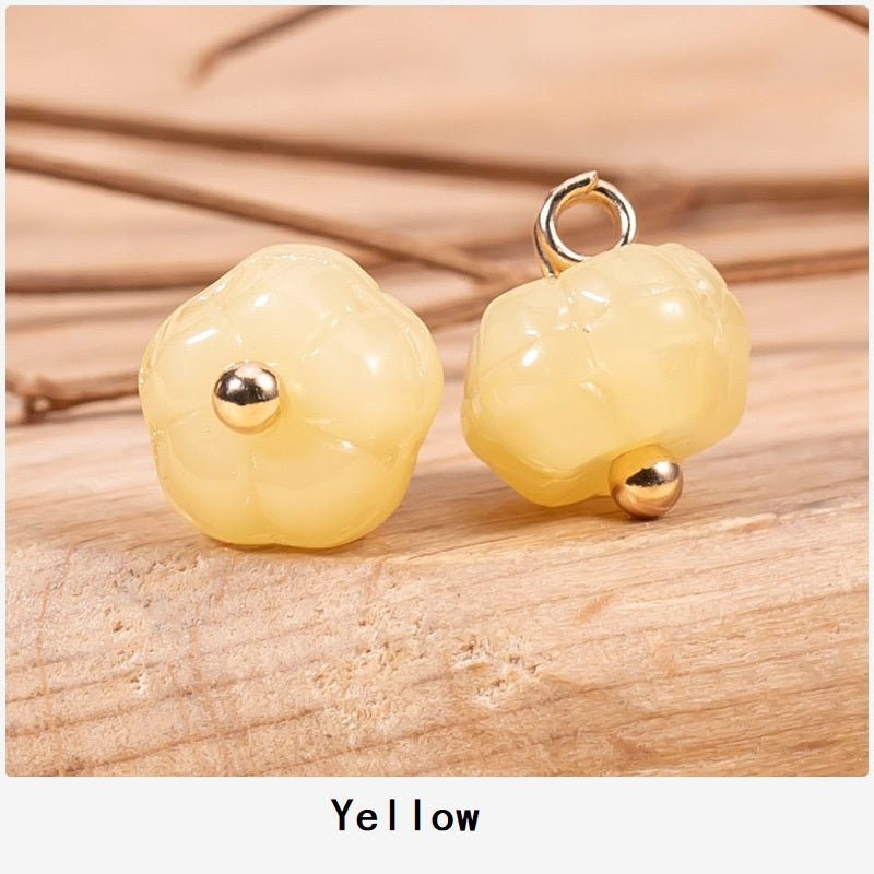 Yellow pumpkin-shaped glazed cheongsam buttons with gold-tone posts and loops