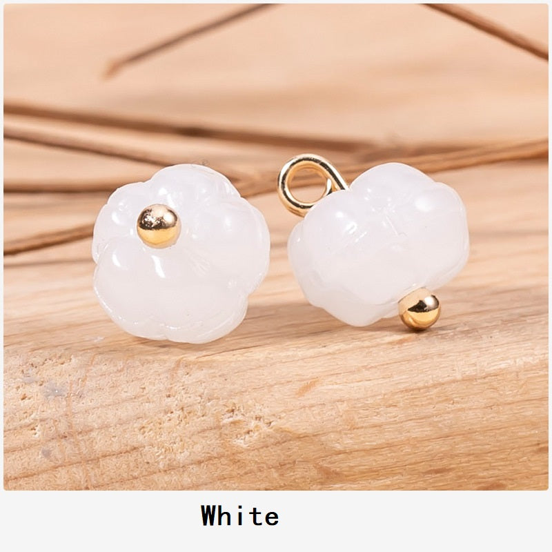 White pumpkin-shaped glazed cheongsam buttons with gold-tone posts and loops