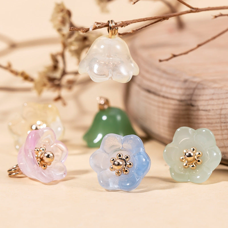 Assorted lily-of-the-valley glaze buttons: pink, light blue, green, and white with gold-tone centers.