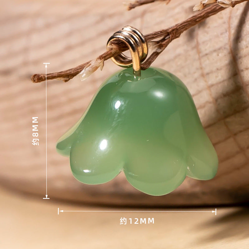 Light green lily-of-the-valley glaze button with gold-tone floral center and top loops.
