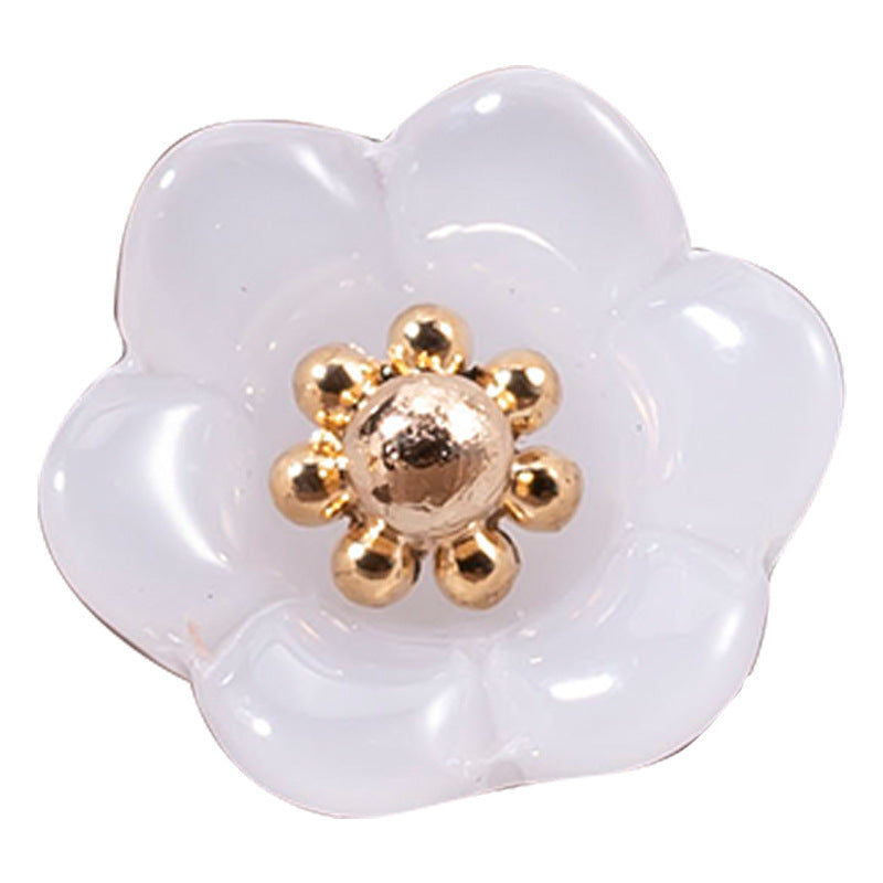 White lily-of-the-valley glaze button with gold-tone floral center and shank loops.