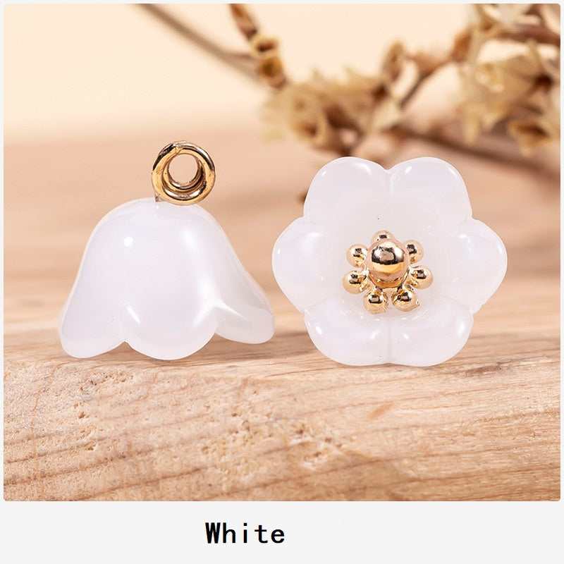 White lily-of-the-valley glaze button pair with gold-tone floral centers and loop shanks.