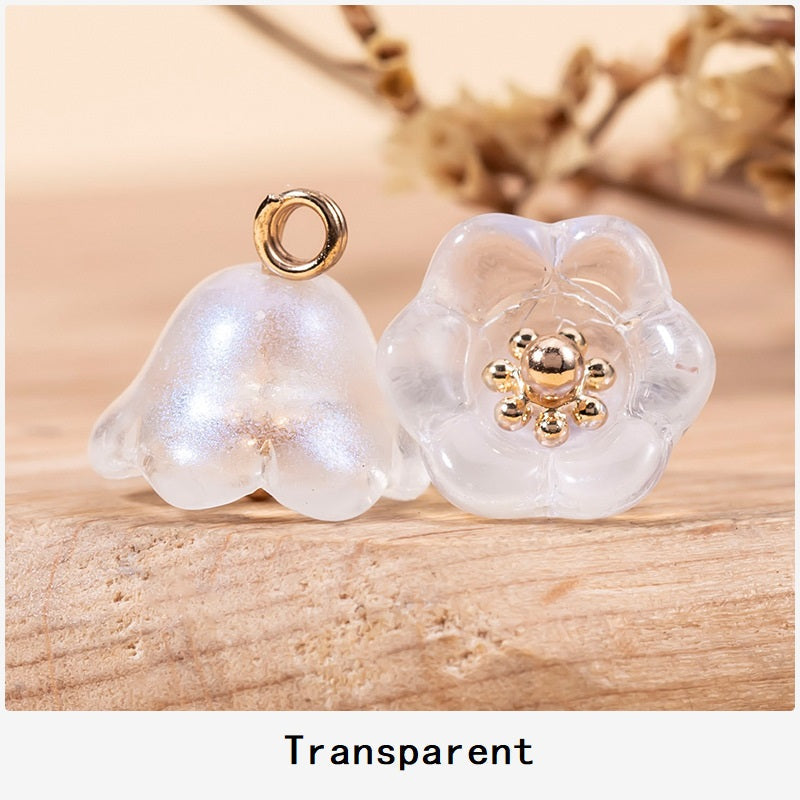 Transparent lily-of-the-valley glaze buttons with gold-tone floral centers and loop shanks.