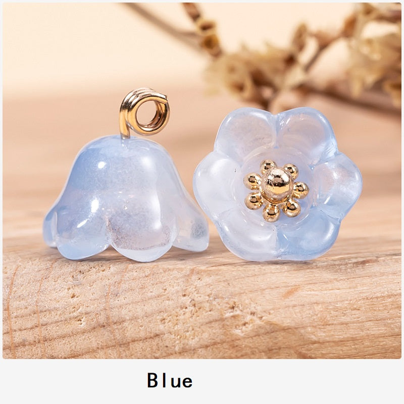 Blue lily-of-the-valley glaze button pair with gold-tone floral centers and loop shanks.