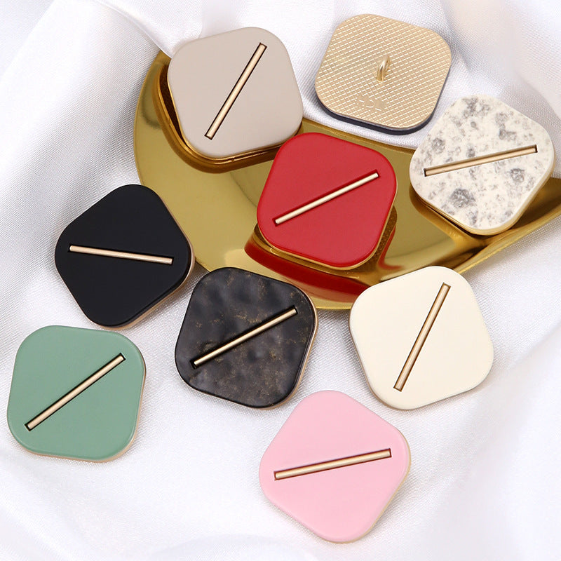 Rounded-square resin coat buttons with gold-tone bars in red, navy, green, pink, cream and dark mottled