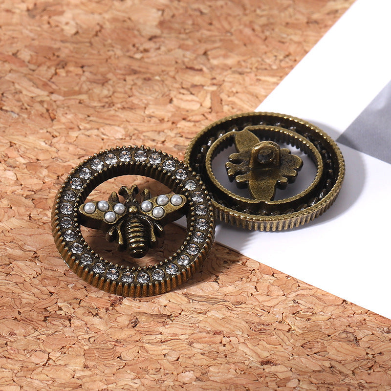 Gold bee rhinestone button, front view with pearl details and sparkling outer ring