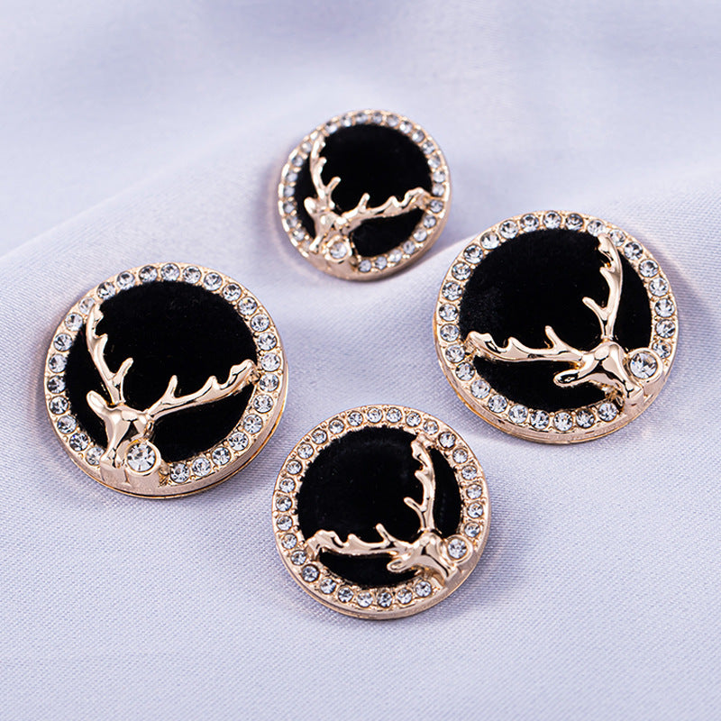 Five golden deer head buttons with black centers and crystal-encrusted edges