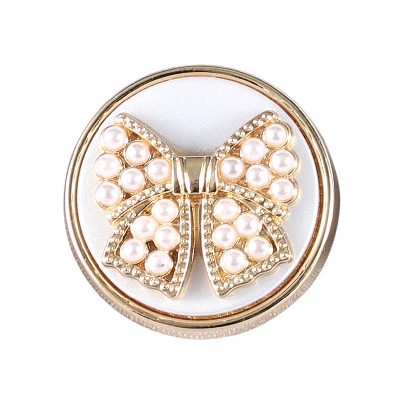 Gold metal shank bowknot button with white faux pearl clusters and rhinestone accents