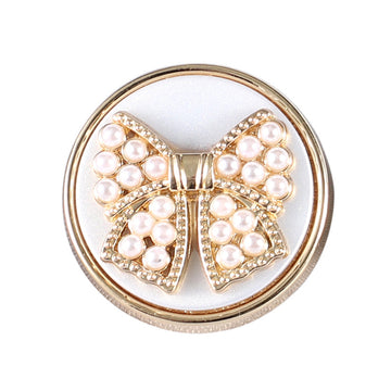 Gold metal shank bowknot button with white faux pearl clusters and rhinestone accents