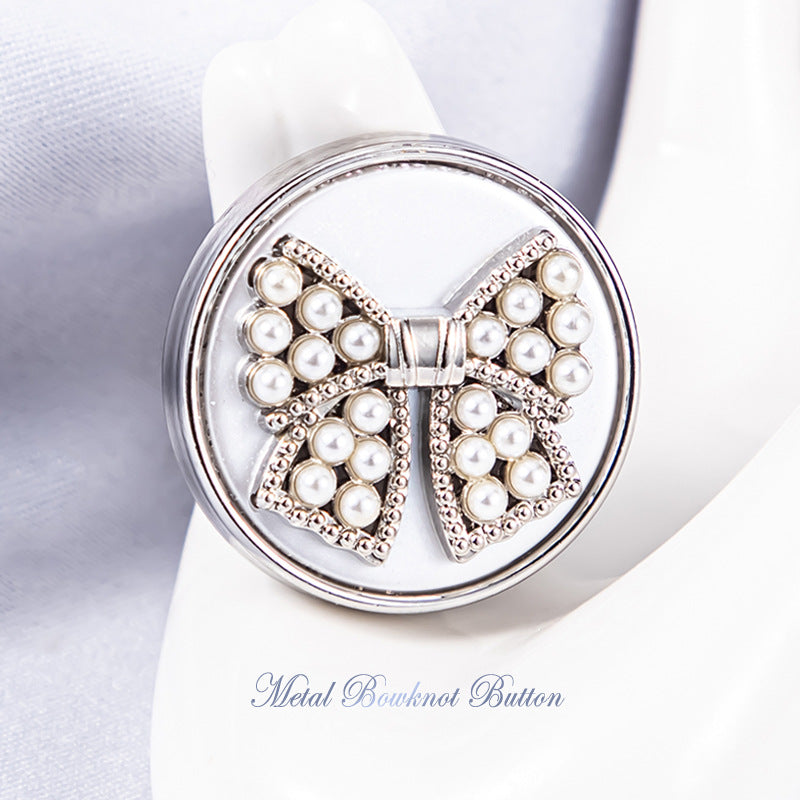 Silver bowknot metal shank button with white faux pearls, rhinestone border, light backing