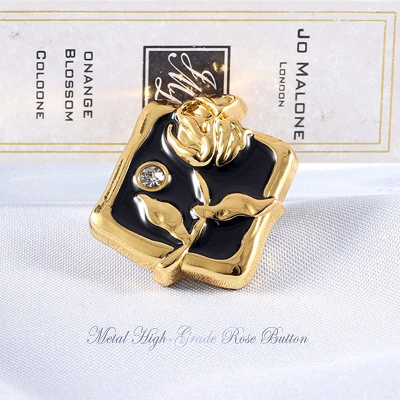 Gold-tone rose rhinestone metal button with black enamel and clear round gem