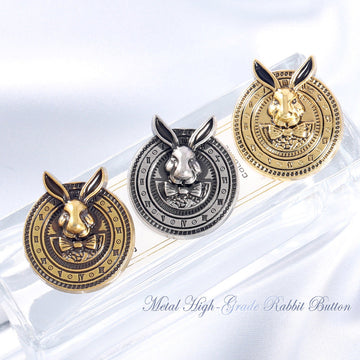 Gold-tone rabbit-head metal coat button with black enamel ears, ornate clock-style rim