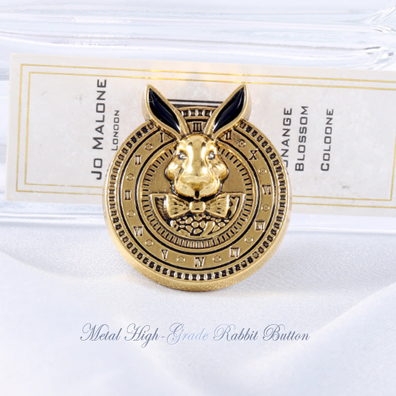 Gold-tone rabbit-head metal coat button with black enamel ears, decorative bow front
