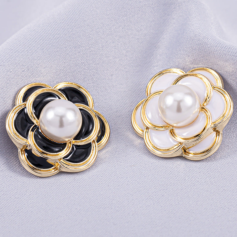 White camellia metal shank button with round white pearl center and gold-tone petals