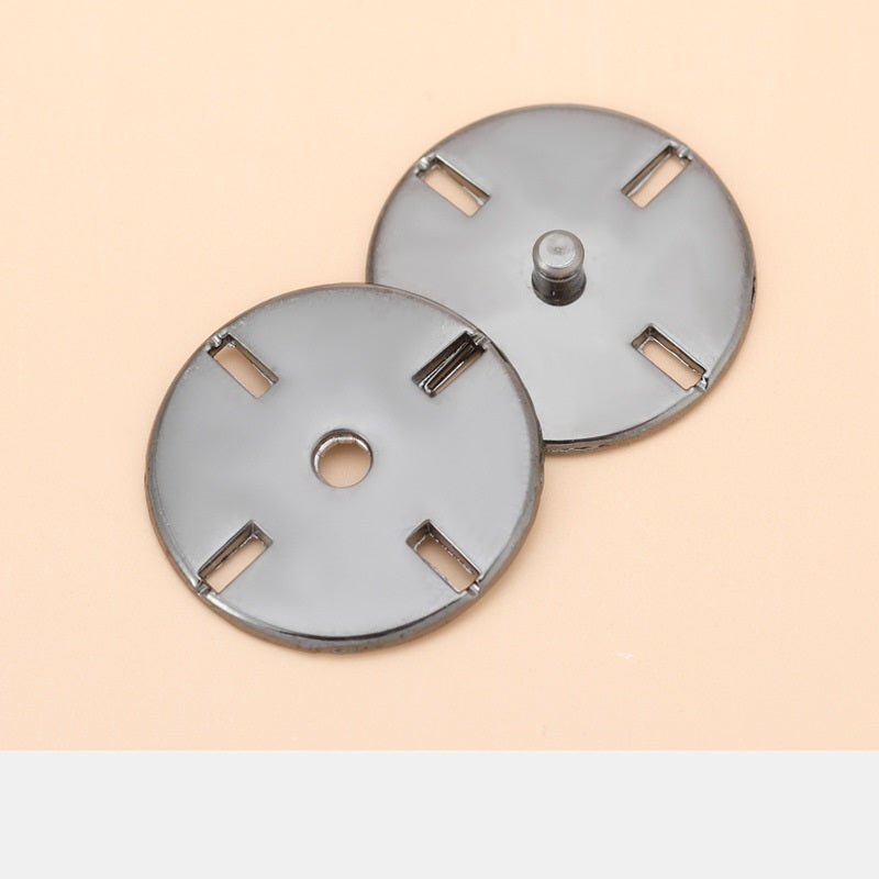 Pair of round metal invisible snap button discs with bar tabs, dark gun/black back plates