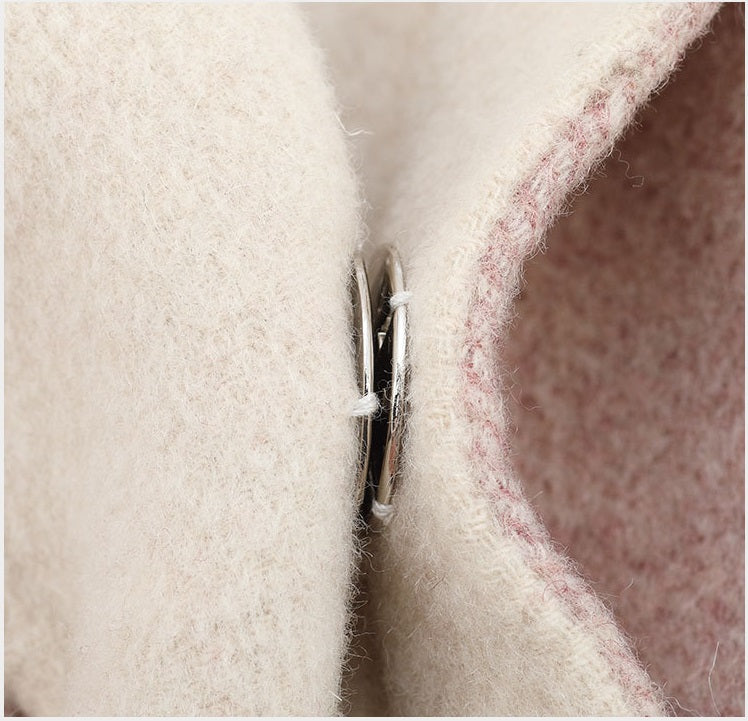Cashmere fabric seam with an invisible snap closure, metal post and pin visible