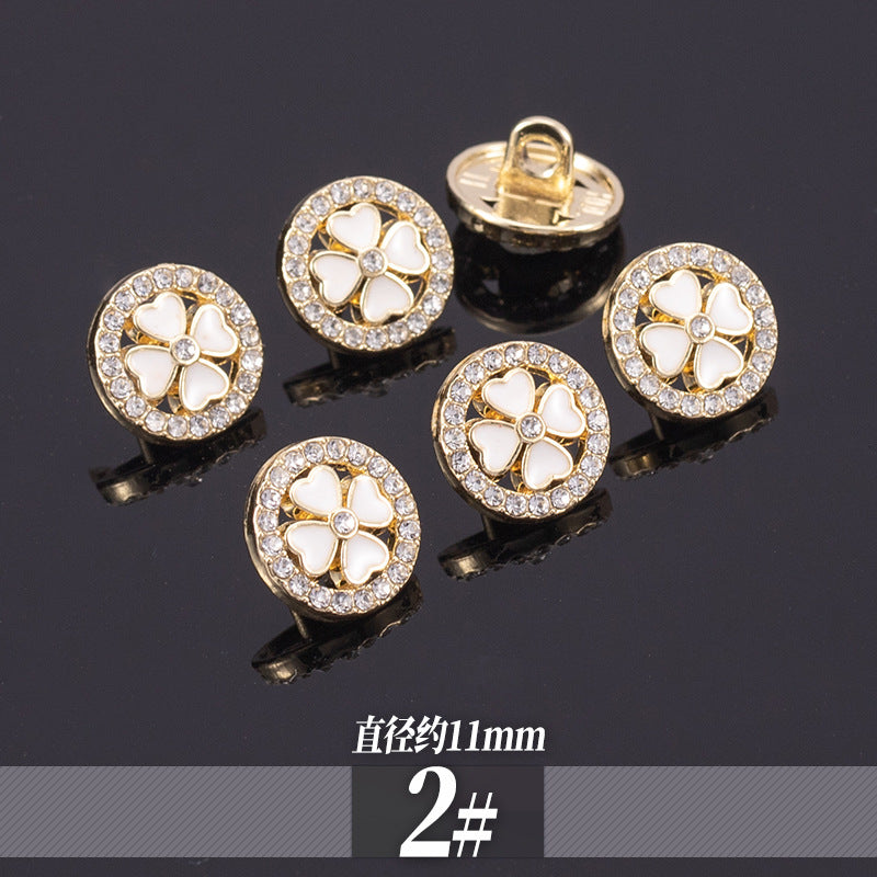Golden rhinestone shirt buttons with white clover flower motif and crystal border; 11-13mm