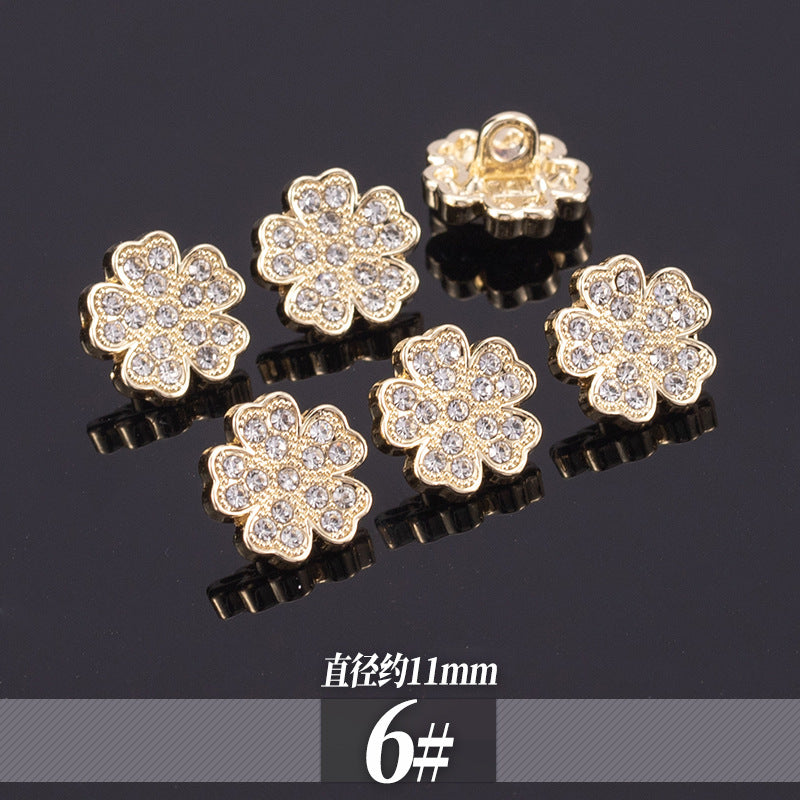 Golden rhinestone shirt buttons with multi-petal flower design and clear stones; 11-13mm
