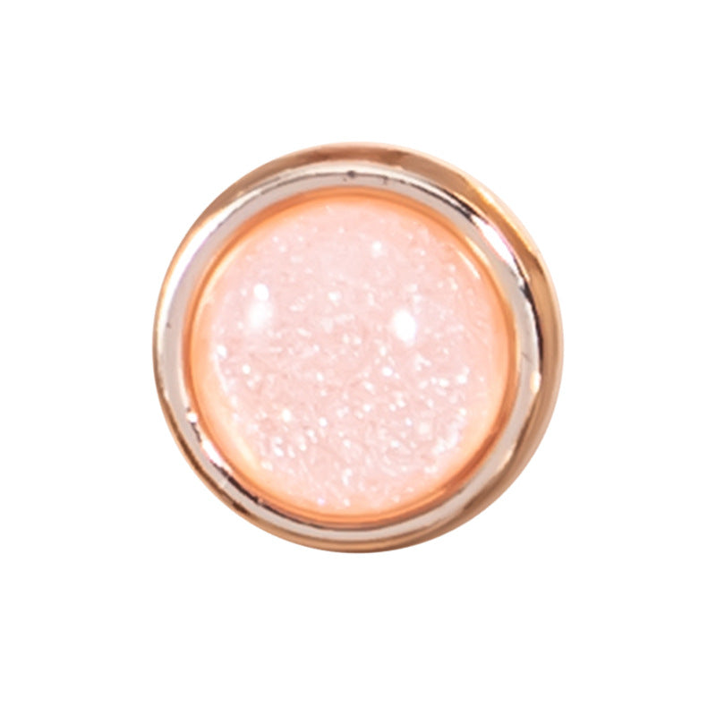 Einzelner Glitzer-Hemdknopf: rosé farbener Resin-Kern mit goldfarbener Metallfassung.