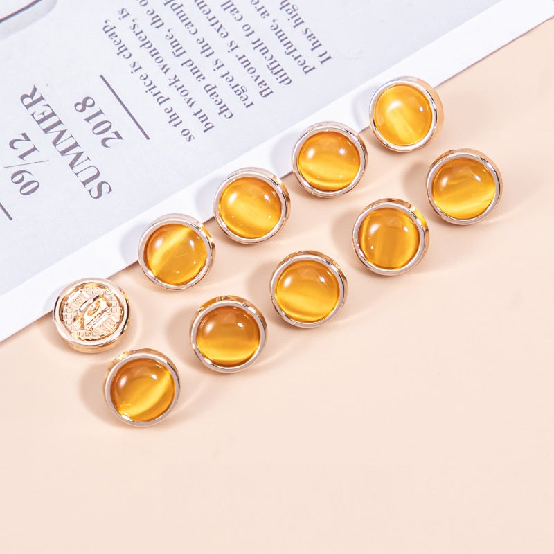 Shirt buttons with amber cat’s eye pearlescent stones, round metal frames