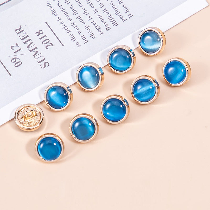 Shirt buttons with blue cat’s eye pearlescent stones, round metal frames