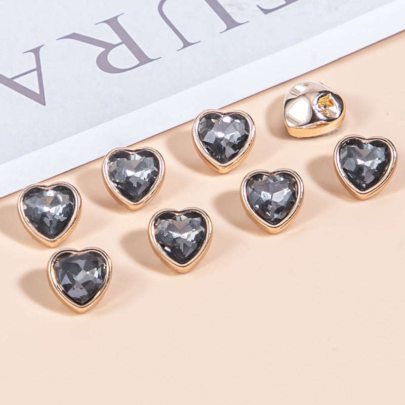 Dark gray heart-shaped crystal shirt buttons with gold-tone metal frames, faceted stones