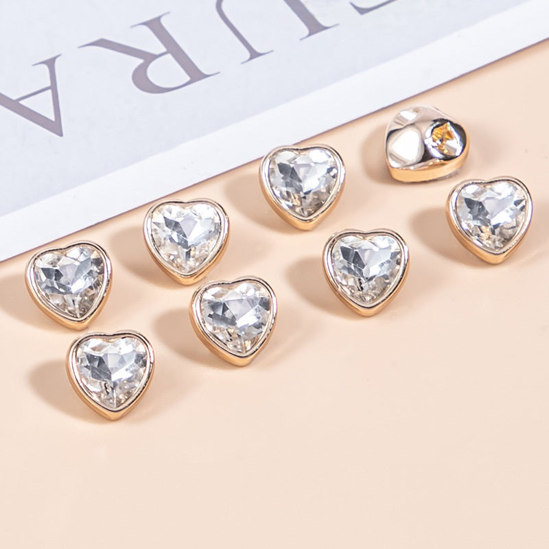 Clear heart-shaped crystal shirt buttons with gold-tone metal bezels, faceted stones