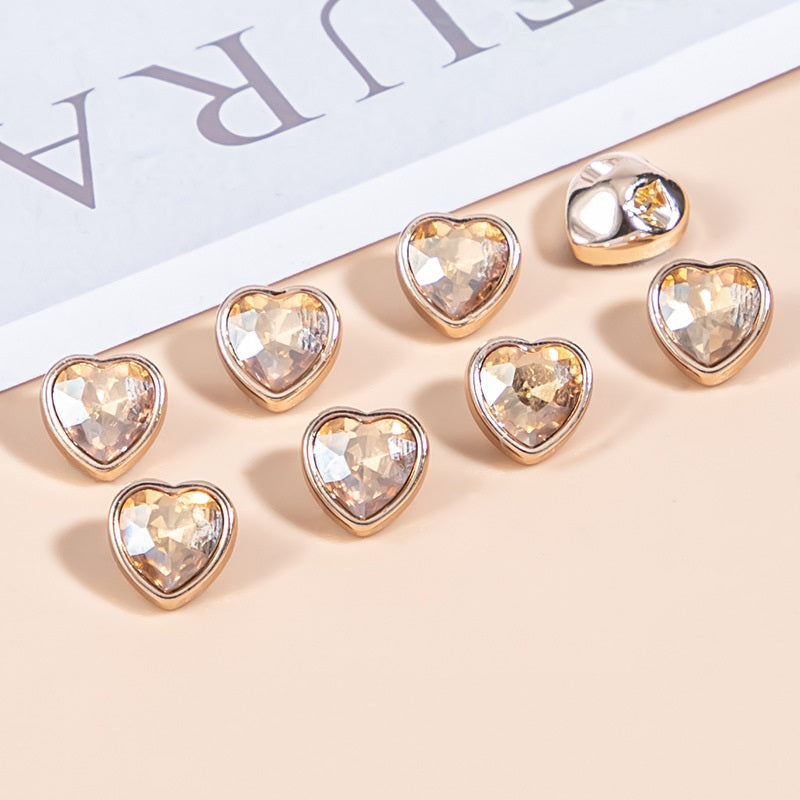 Champagne tan heart-shaped crystal shirt buttons with gold-tone metal bezels, faceted stones