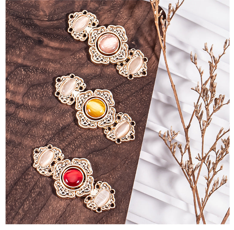 Embossed flower metal buckle buttons with pink pearl stones, yellow center, and red gem