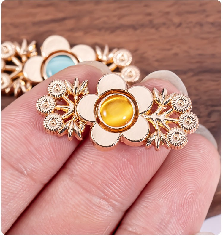 Cat’s eye branch flower metal lock button in gold tone with orange-yellow center stone