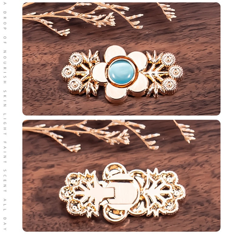 Branch flower metal lock button with light blue cat’s eye stone, rose-gold tone