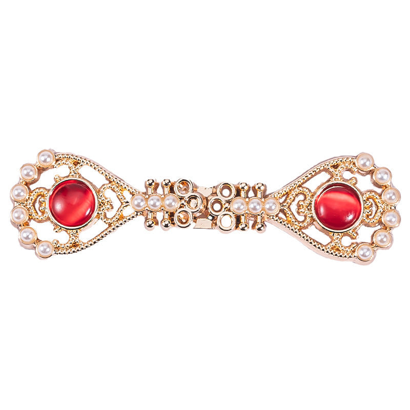 Pipa-shaped metal button with red oval stone and pearl-gold filigree edges
