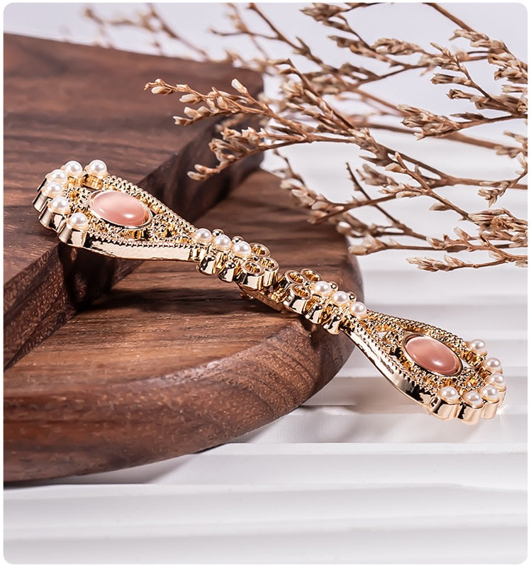 Pipa-shaped metal button bracelet design with peach-pink oval stones and pearls
