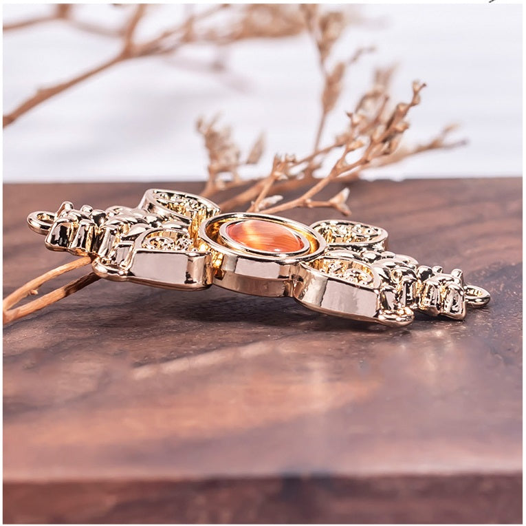 Side view cat’s eye metal buckle, gold-toned clasp band with small pavé details.