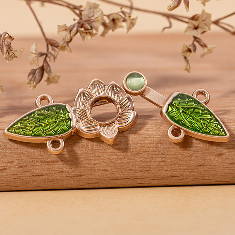 Green cat’s eye leaf lock buttons with lotus-style centers and metal loops