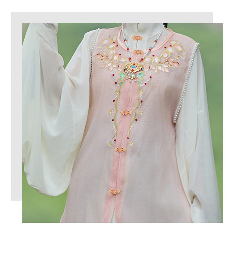 Rose-gold lotus cat’s eye lock buttons on light pink dress front with decorative trim